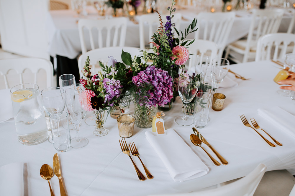 Table Flowers Centrepiece Purple Pink Hydrangea Dahlia Bottles Butley Priory Wedding Sally Rawlins Photography