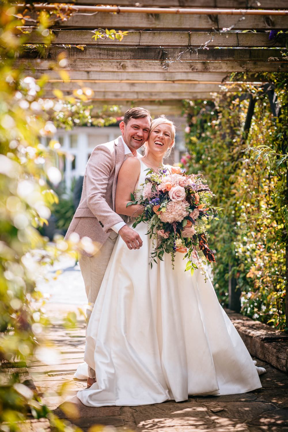 Bride Bridal V Neck Justin Alexander Dress Gown A Line Pink Salmon Custom Suit Groom Trailing Bouquet Carousel Wedding Sarah Legge Photography