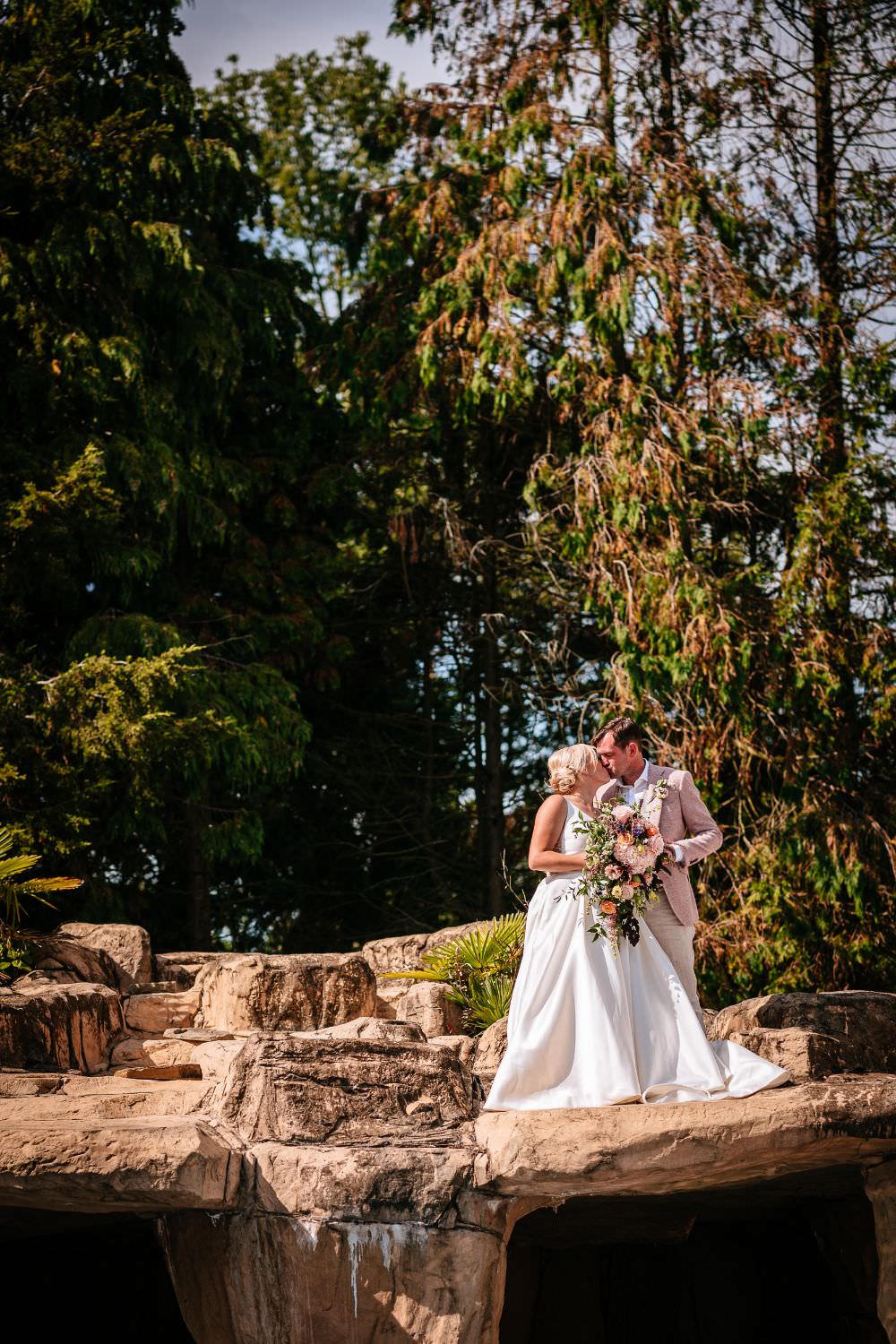 Bride Bridal V Neck Justin Alexander Dress Gown A Line Pink Salmon Custom Suit Groom Trailing Bouquet Carousel Wedding Sarah Legge Photography