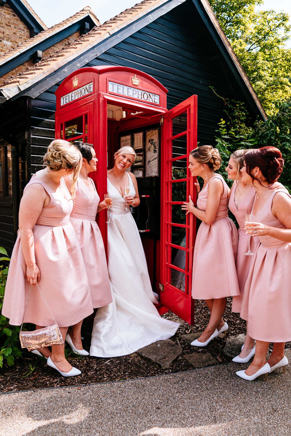 Bride Bridal V Neck Justin Alexander Dress Gown A Line Pink Bridesmaids Telephone Box Guest Book Booth Carousel Wedding Sarah Legge Photography