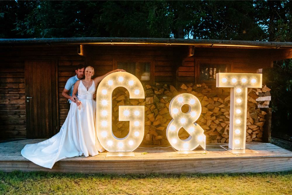 Light Up Letters Initials Bride Bridal V Neck Justin Alexander Dress Gown A Line Waistcoat Groom Carousel Wedding Sarah Legge Photography