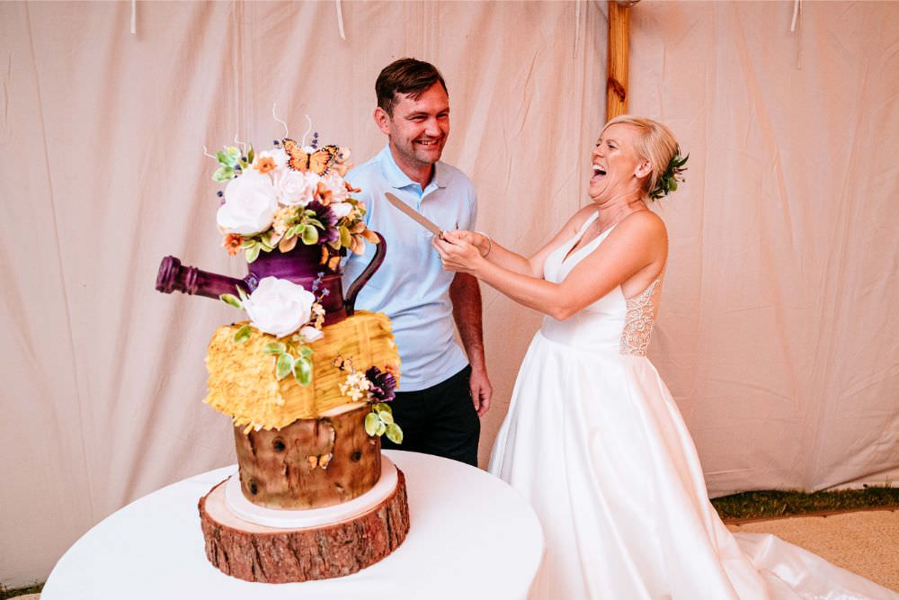 Rustic Cake Wood Slice Cake Cutting Bride Bridal V Neck Justin Alexander Dress Gown A Line Carousel Wedding Sarah Legge Photography