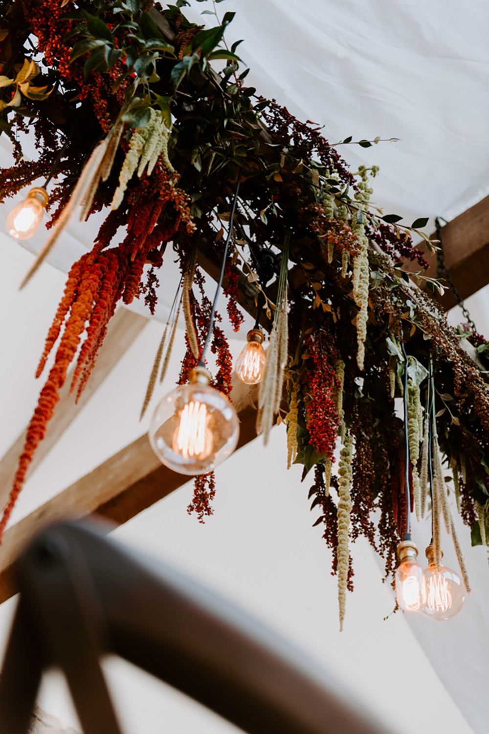 Table Tablescape Decor Decoration Autumn Fall Flowers Wooden Long Candles Dahlia Coral Greenery Suspended Hanging Flowers Foliage Light Bulbs Lighting Ethical Wedding Ideas Sadie Osborne Photography