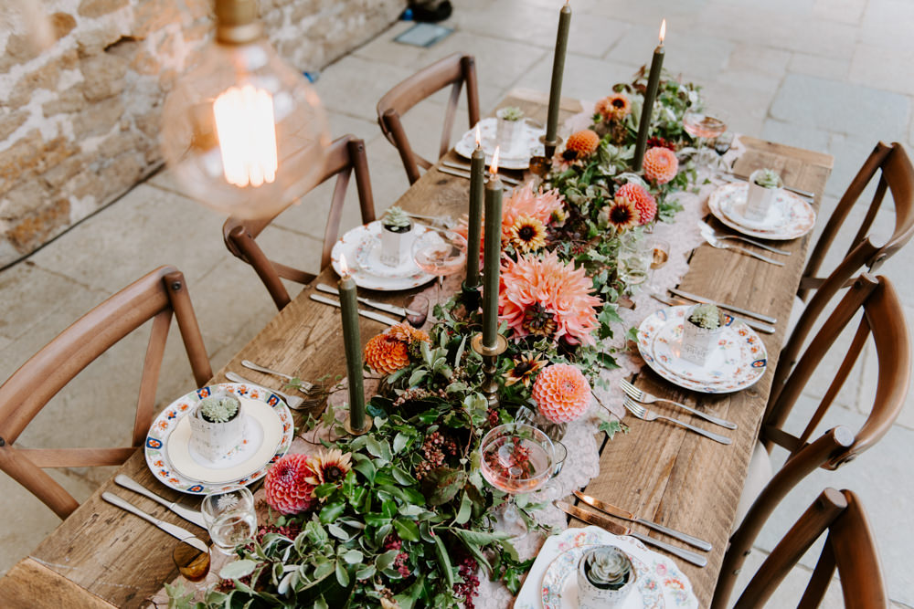 Table Tablescape Decor Decoration Autumn Fall Flowers Wooden Long Candles Dahlia Coral Greenery Suspended Hanging Flowers Foliage Light Bulbs Lighting Ethical Wedding Ideas Sadie Osborne Photography
