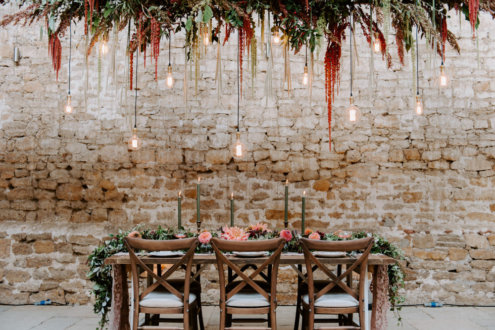 Table Tablescape Decor Decoration Autumn Fall Flowers Wooden Long Candles Dahlia Coral Greenery Suspended Hanging Flowers Foliage Light Bulbs Lighting Ethical Wedding Ideas Sadie Osborne Photography