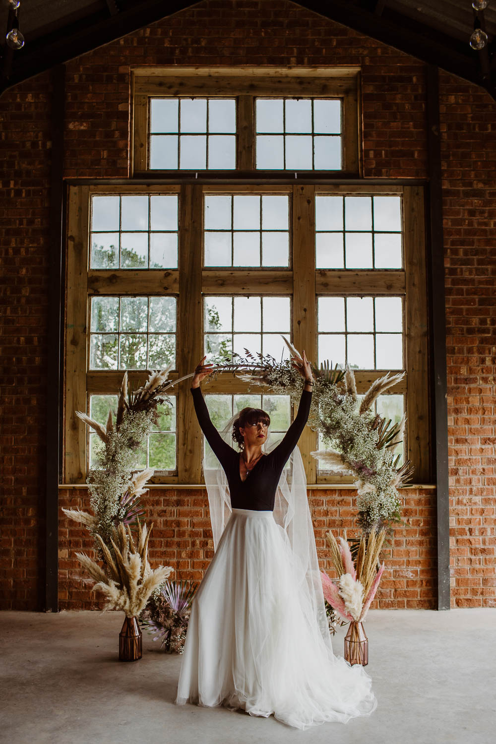 Bride Bridal Ballet Top Shirt Shoes Moon Gate Flower Arch Pampas Grass Backdrop Ceremony Venue Giraffe Shed Wedding When Charlie Met Hannah