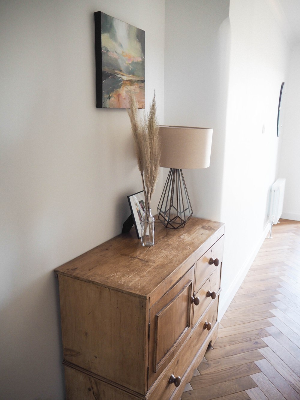 Hallway Renovation 1930s Antique Pine Chest of Drawers Glass Table Lamp Picture Frame Glass Bottle Pampas Grass Art Work Painting