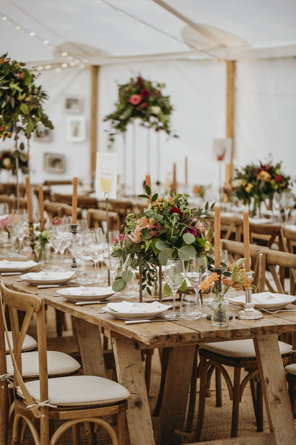 Long Wooden Tables Cross Back Chairs Tall Flowers Arrangements Centrepiece Greenery Foliage Kent Marquee Wedding Lily Bungay and Co