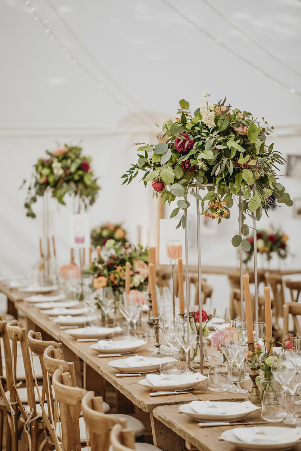 Long Wooden Tables Cross Back Chairs Tall Flowers Arrangements Centrepiece Greenery Foliage Kent Marquee Wedding Lily Bungay and Co