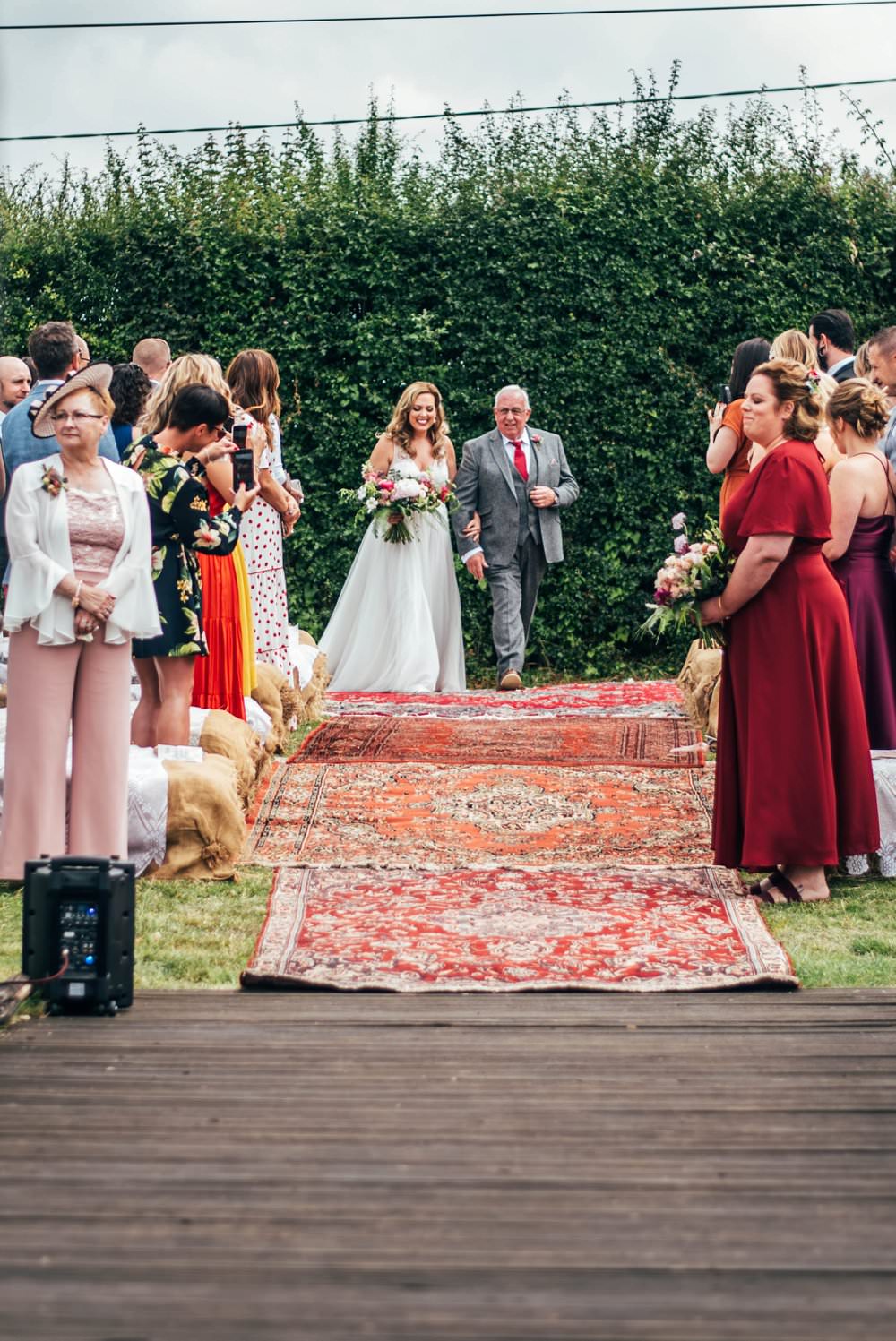 Outdoor Ceremony Persian Rugs Hay Bales Pink Red Wedding Three Flowers Photography