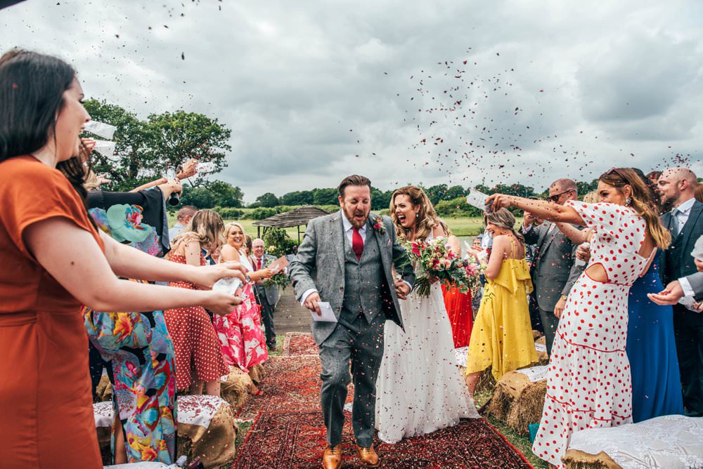 Confetti Outdoor Ceremony Persian Rugs Hay Bales Pink Red Wedding Three Flowers Photography