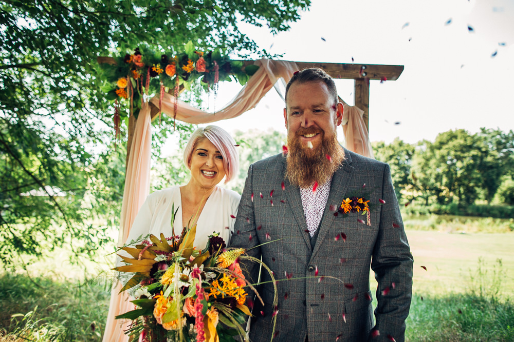 Retro Wedding Ideas Emily Little Wedding Photography Wooden Arbour Backdrop Fabric Drapes Flowers