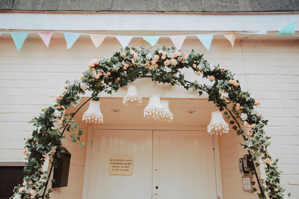 Floral Greenery Arch Entrance Lampshades Bunting Willingale Village Hall Wedding Photographer Liam Gillan