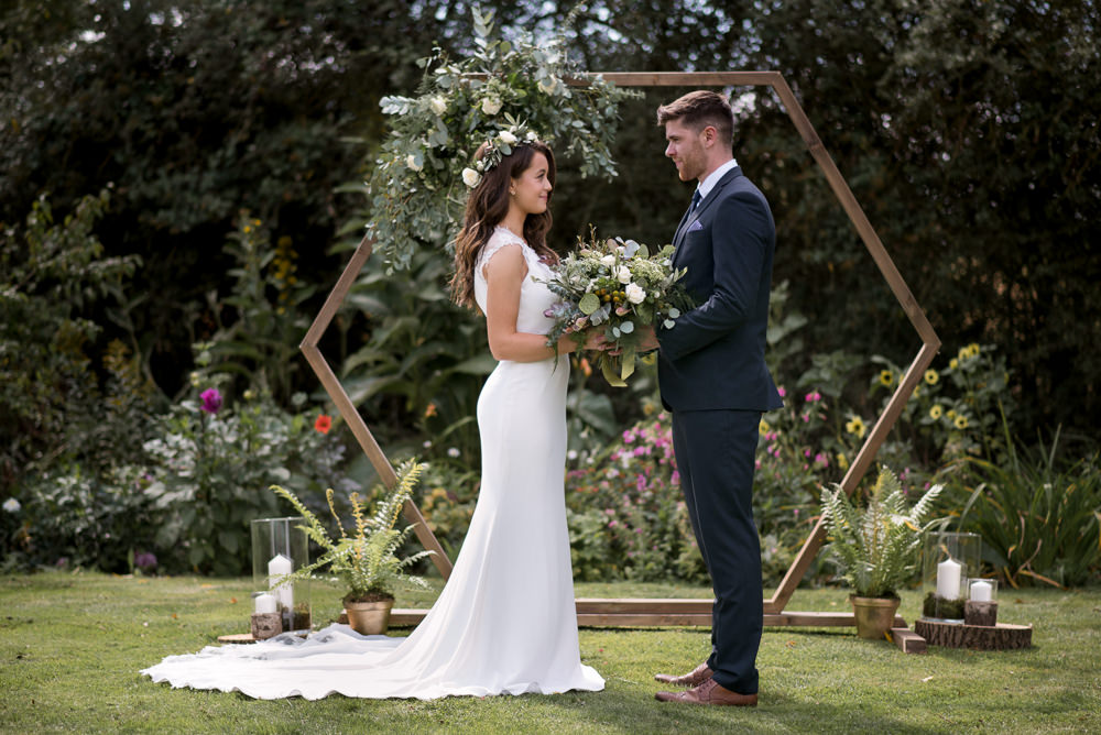 Geometric Backdrop Greenery Foliage Flowers Arch Ceremony Aisle Hexagon Minimalist Wedding Ideas Nicola Belson Photography