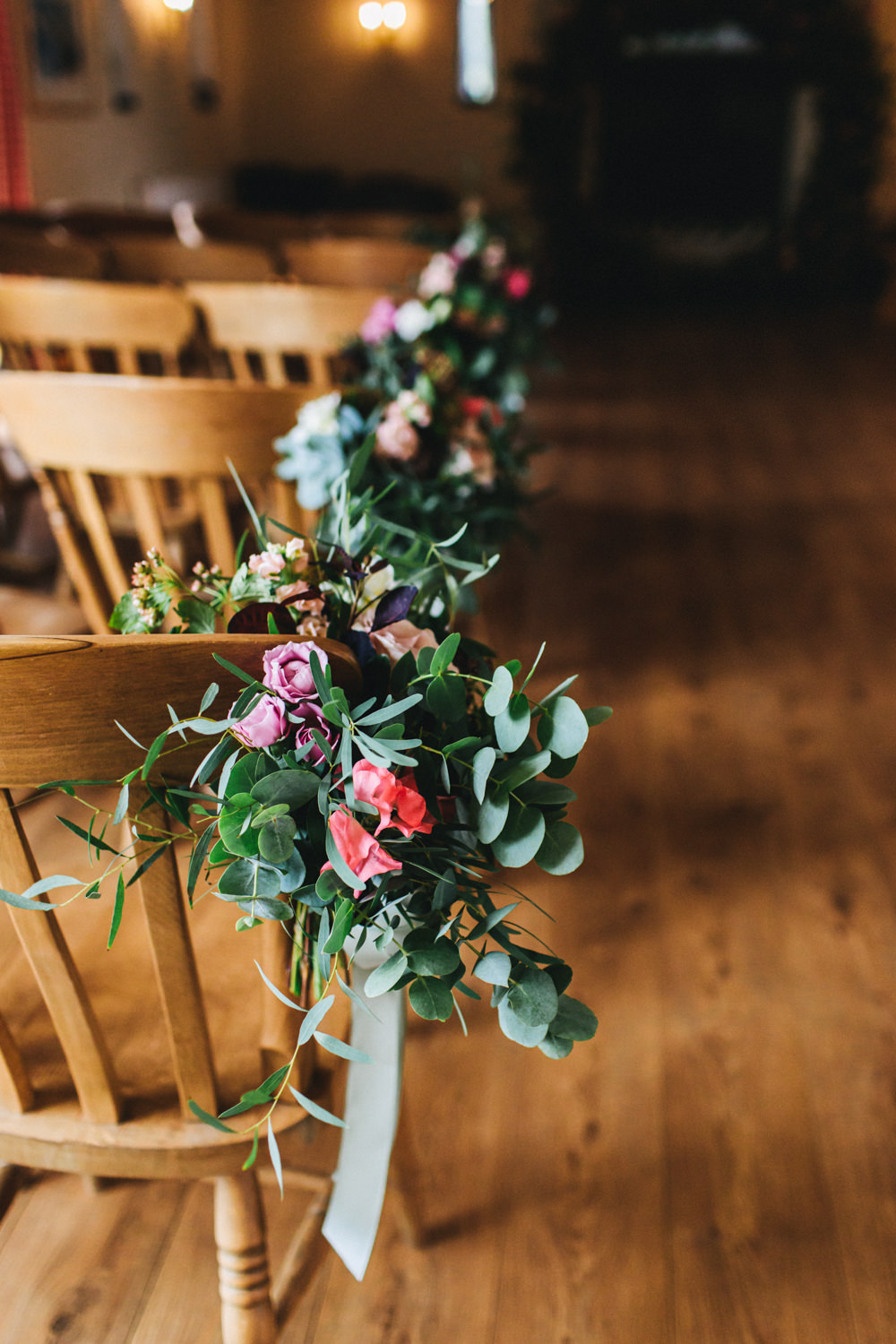 Flowers Ceremony Aisle Chairs Pew End Flowers Greenery Foliage Sweetpeas Freesias Peony Rose Burgundy Pink Outbuildings Wedding Jessica O'Shaughnessy Photography