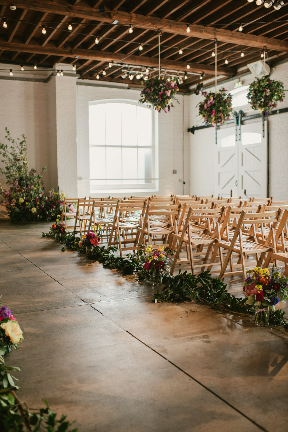 Ceiling Hanging Suspended Flowers Decor Spring Coral Peony Natural Wild Colourful Aisle Riverside London Wedding Ellie Gillard Photography