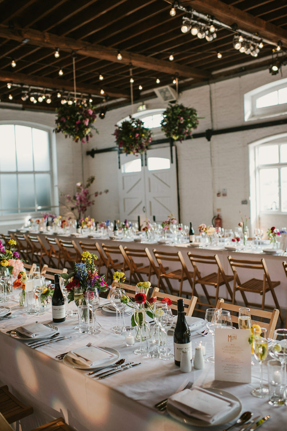 Ceiling Hanging Suspended Flowers Decor Spring Coral Peony Natural Wild Colourful Long Tables Riverside London Wedding Ellie Gillard Photography