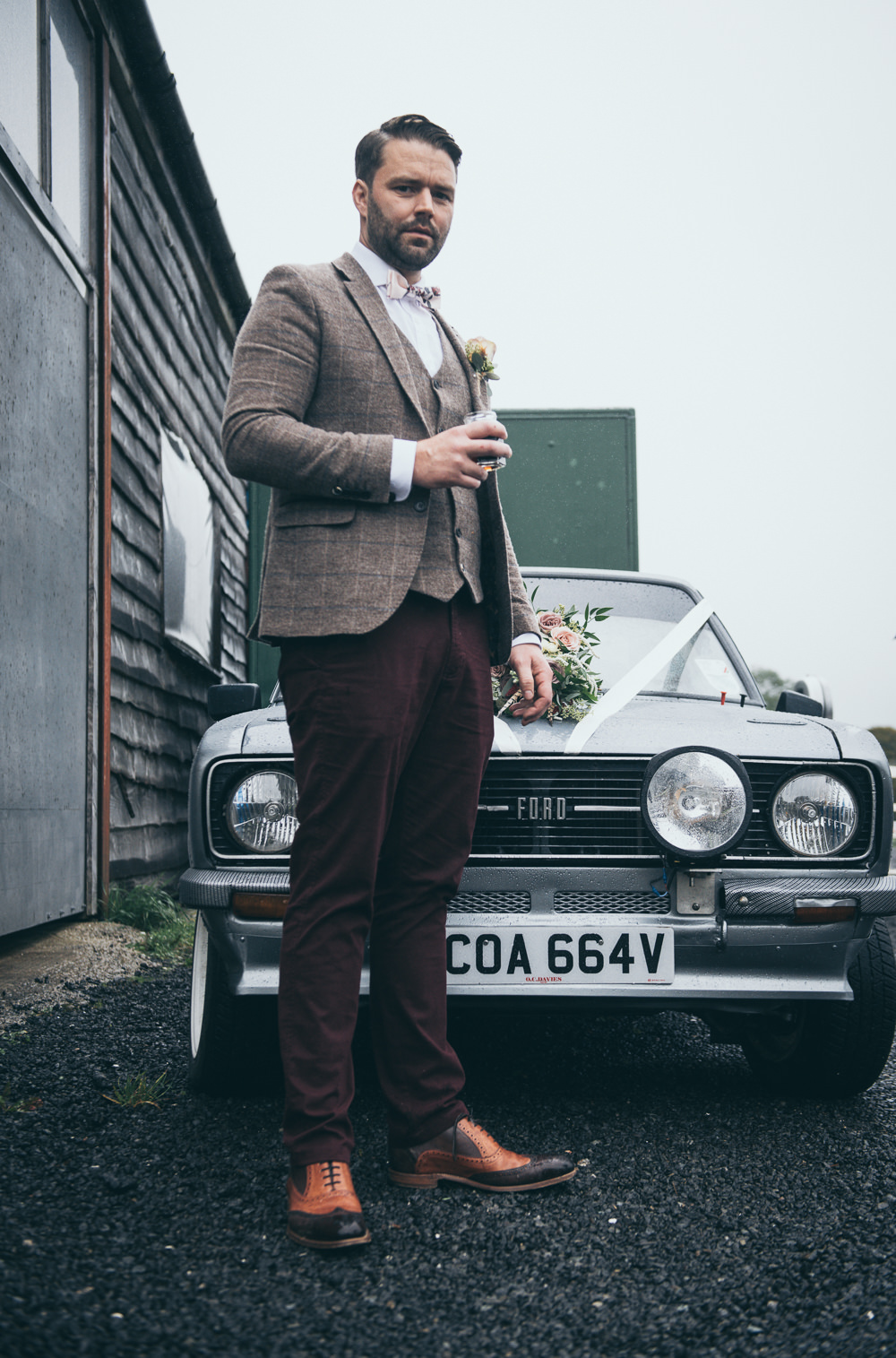Groom Tweed Suit Brown Check Burgundy Chinos Floral Bow Tie Car Transport Vintage Ford Fron Farm Yurt Retreat Wedding Cat Arwel Photography