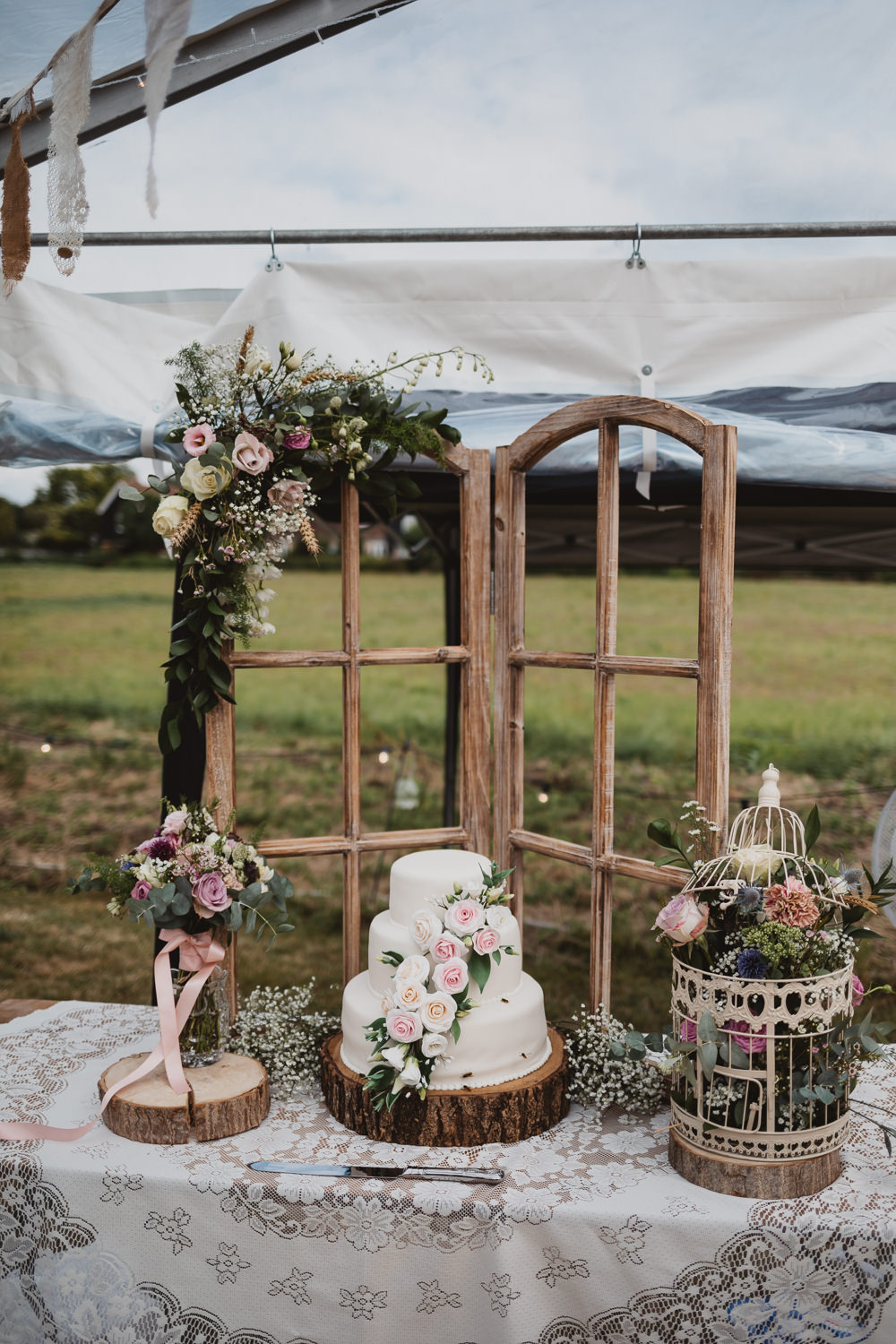 Iced Cake Sugar Flowers Log Slice Stand Table Wooden Windo Frame Flowers Clear Marquee Wedding Sarah Brookes Photography