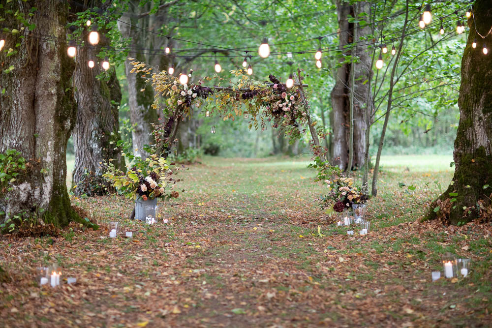 Flower Arch Backdrop Ceremony Woodland Trees Festoon Lights Château Elopement France Maru Photography