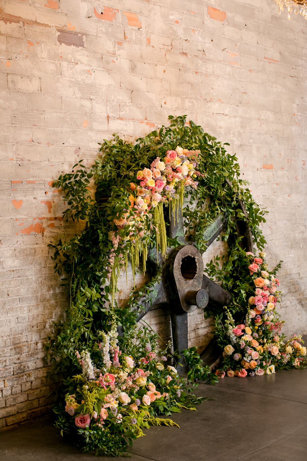 Wooden Wheel Flowers Backdrop Greenery Foliage Peony Rose Floral Minneapolis Wedding Jeannine Marie Photography