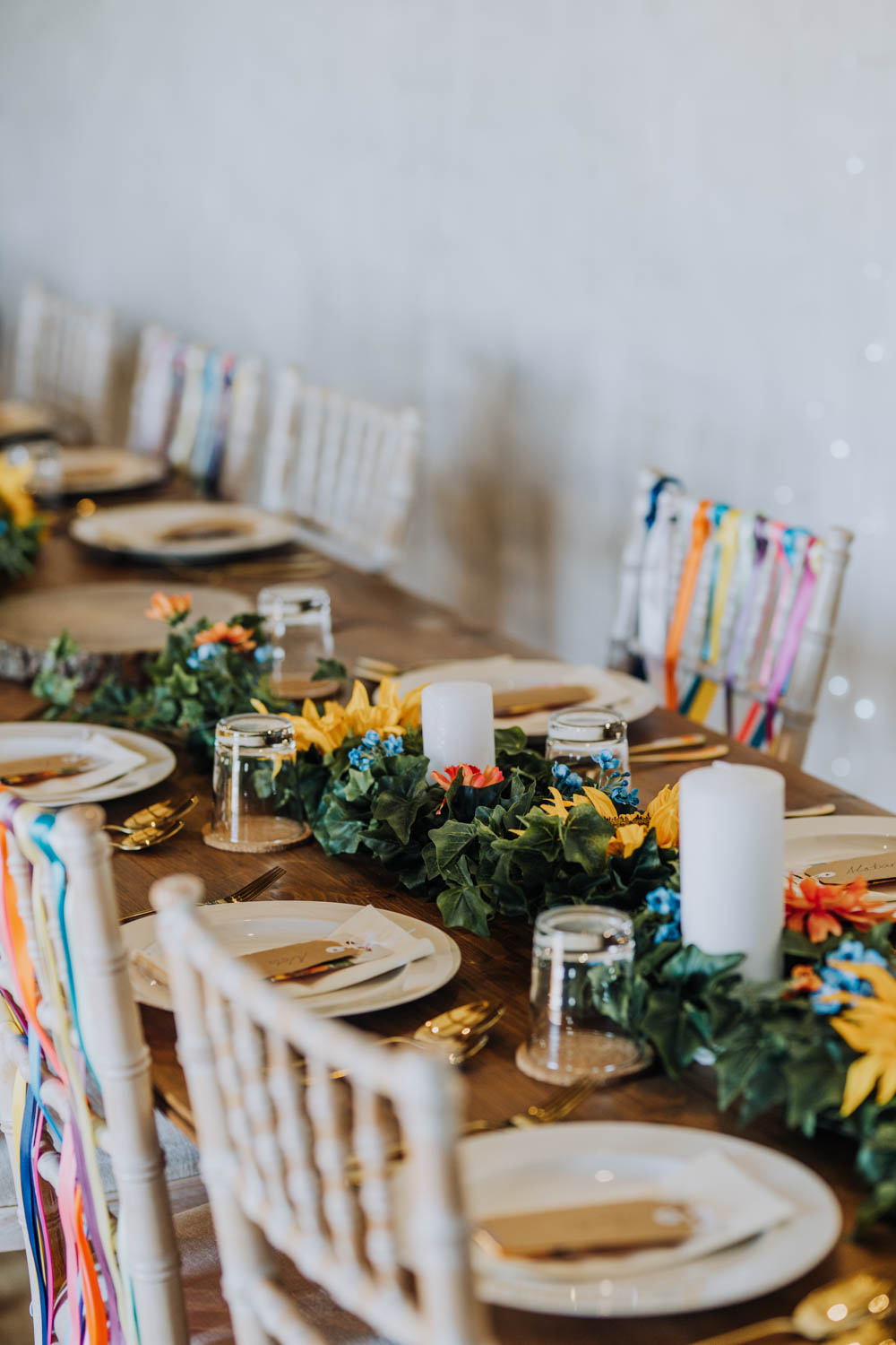 Rainbow Riboons Chairs Decor Long Tables Candles Greenery Foliage Chypraze Wedding Barn Clara Cooper Photography