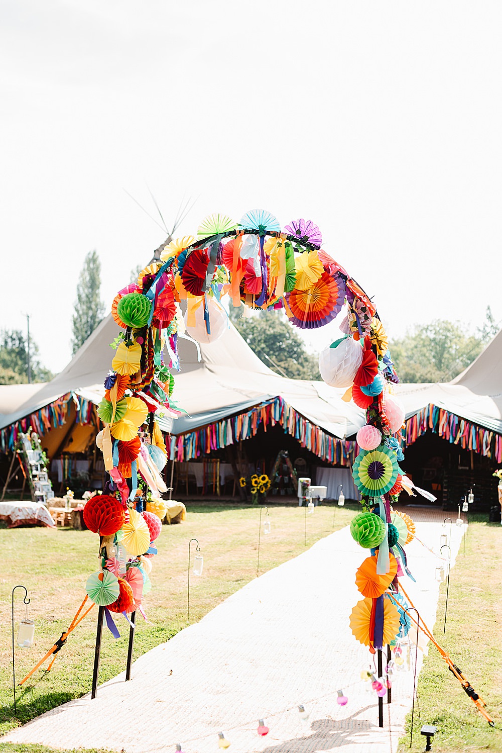 Arch Colourful Rainbow Multicolour Entrance Pom Poms Ribbons Pinwheels DIY Tipi Wedding Fiona Kelly Photography