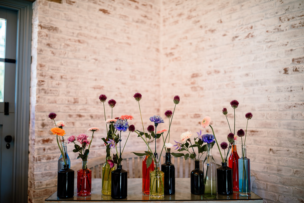 Centepiece Flowers Wild Flowers Decor Table Bottles Sperry Tent Wedding Hayley Baxter Photography