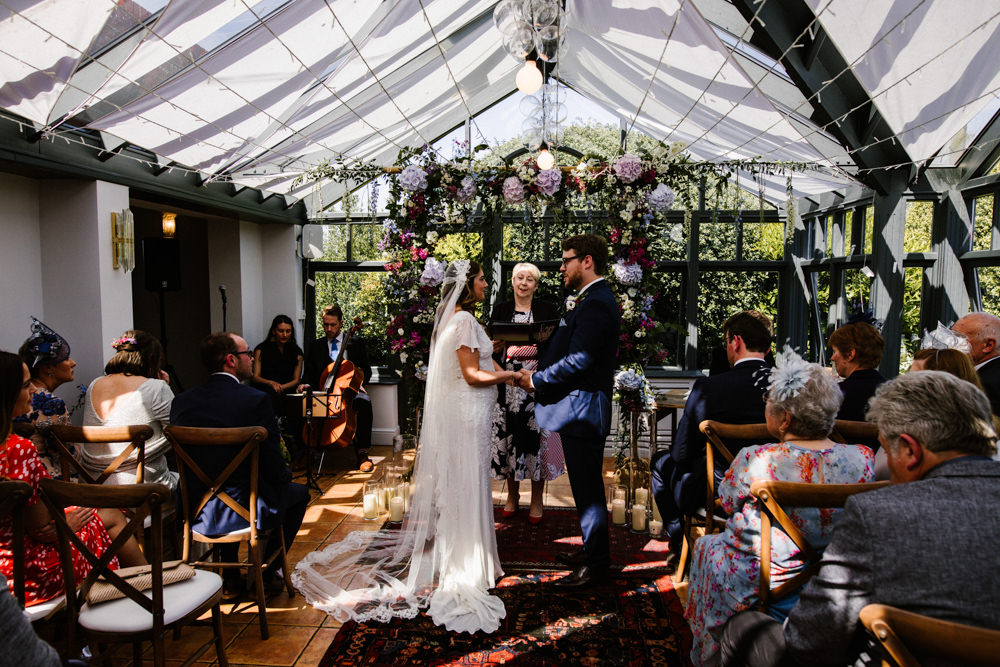 Ceremony Aisle Backdrop Rugs Flowers Flower Arch Conservatory Titchwell Manor Wedding Honey and The Moon Photography