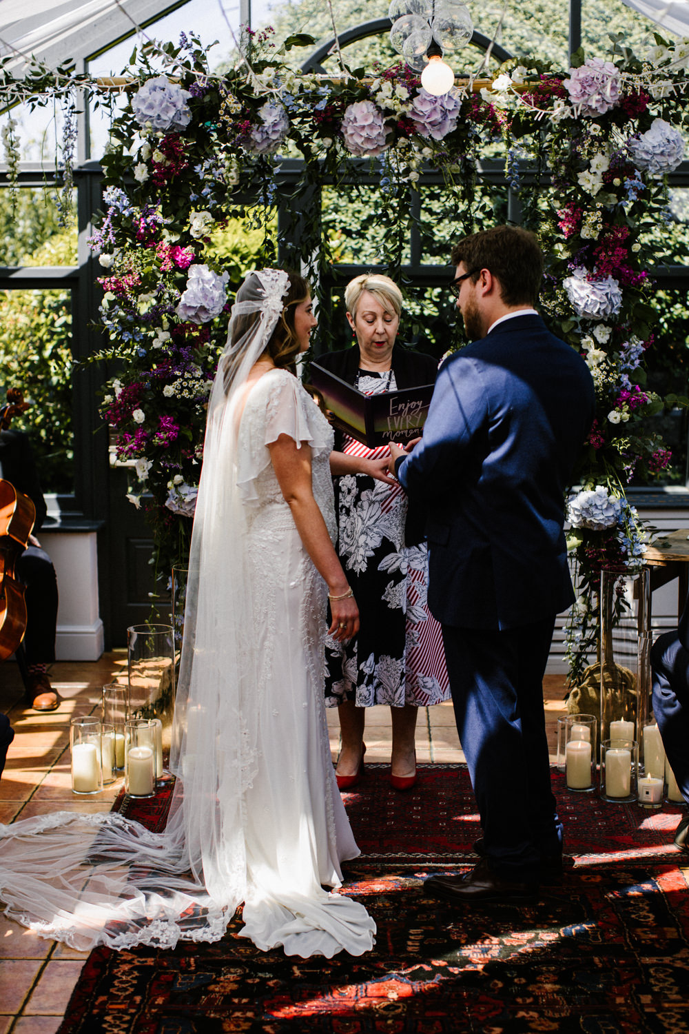 Ceremony Aisle Backdrop Rugs Flowers Flower Arch Conservatory Titchwell Manor Wedding Honey and The Moon Photography