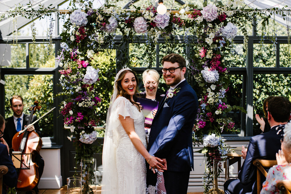 Ceremony Aisle Backdrop Rugs Flowers Flower Arch Conservatory Titchwell Manor Wedding Honey and The Moon Photography