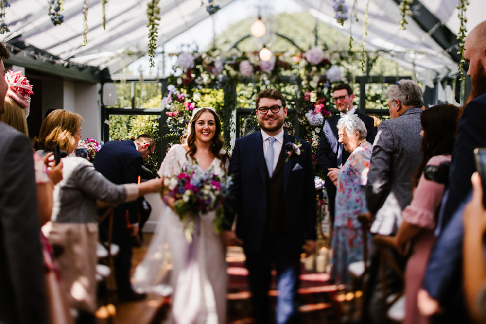 Ceremony Aisle Backdrop Rugs Flowers Flower Arch Conservatory Titchwell Manor Wedding Honey and The Moon Photography