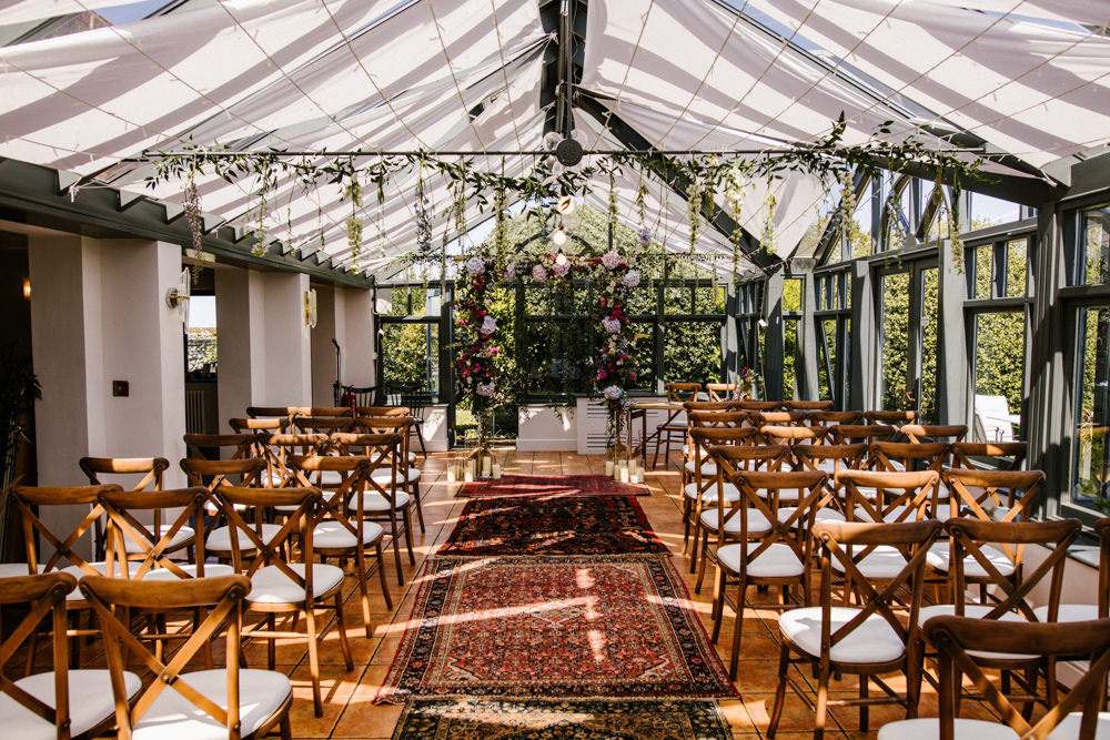 Hanging Flowers Suspended Florals Decor Conservatory Ceremony Aisle Rugs Titchwell Manor Wedding Honey and The Moon Photography