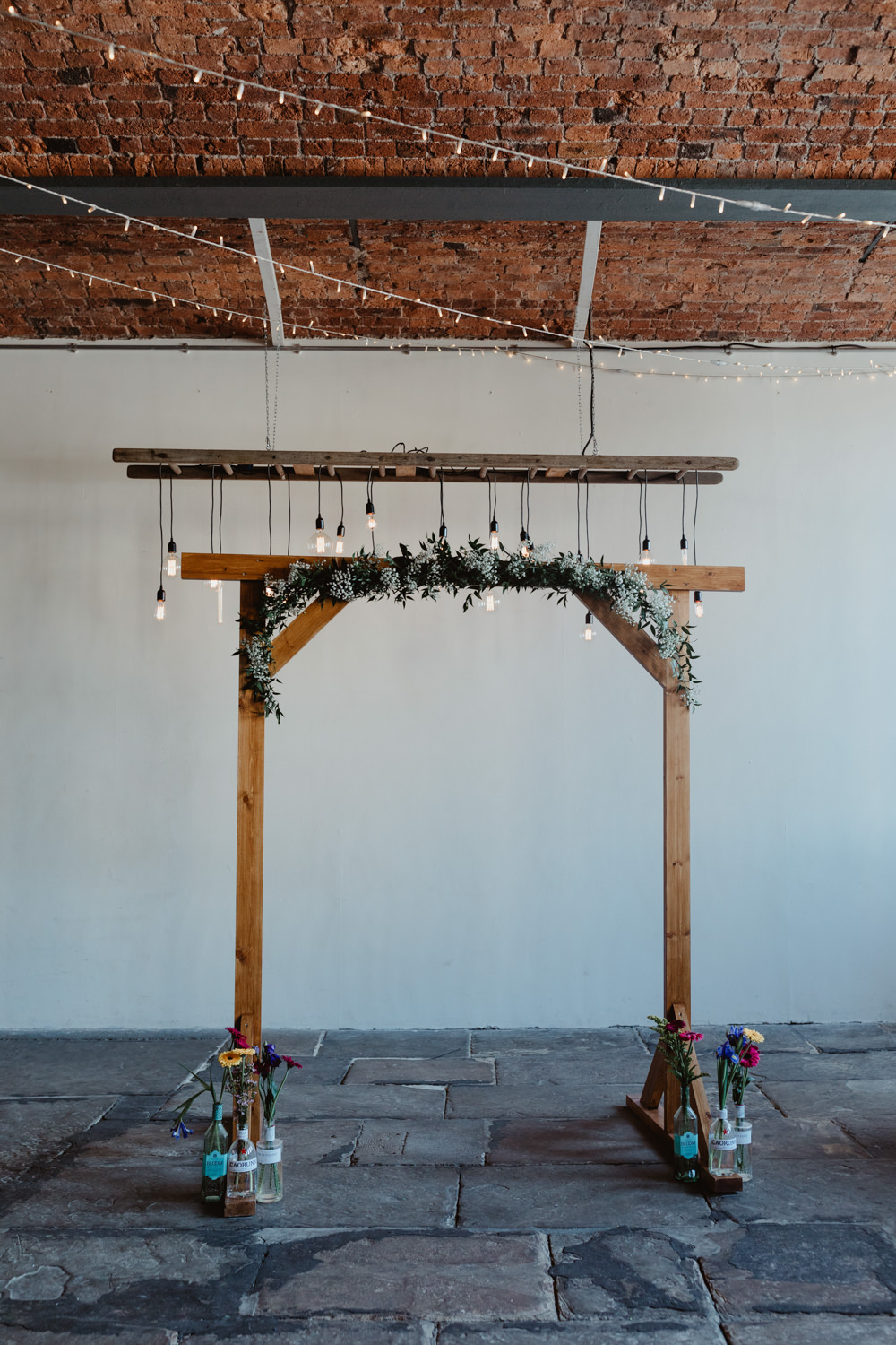 Wooden Frame Backdrop Arch Greenery Foliage Festoon Lights Edison Lighting Arches Dean Clough Wedding Stevie Jay Photography