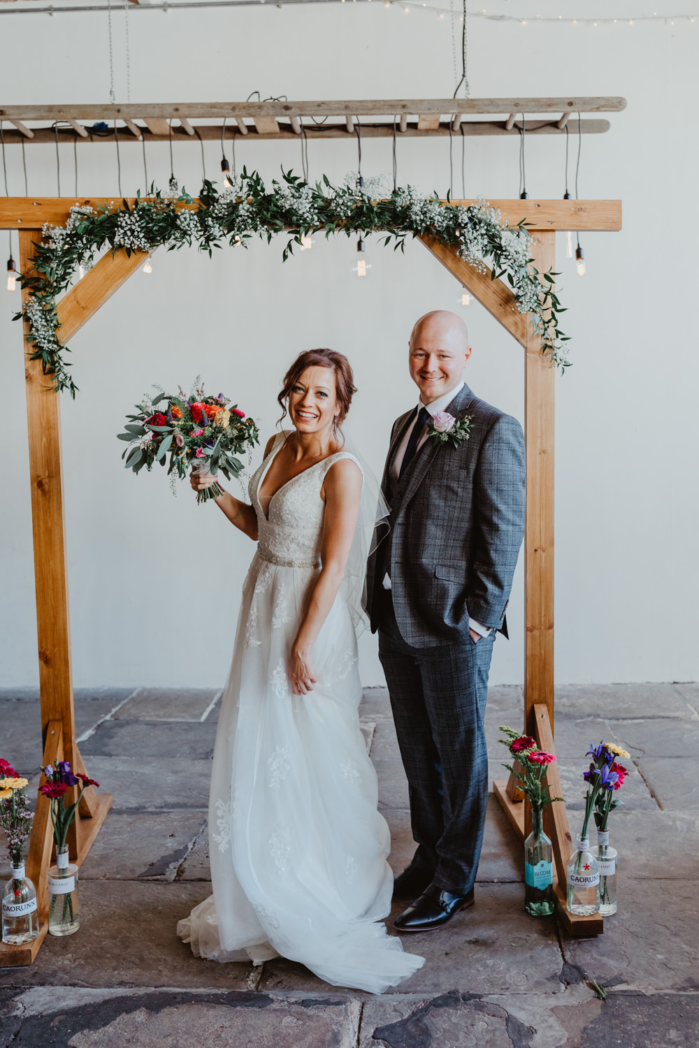 Arches Dean Clough Wedding Stevie Jay Photography Wooden Frame Backdrop Arch Greenery Foliage Festoon Lights Edison Lighting