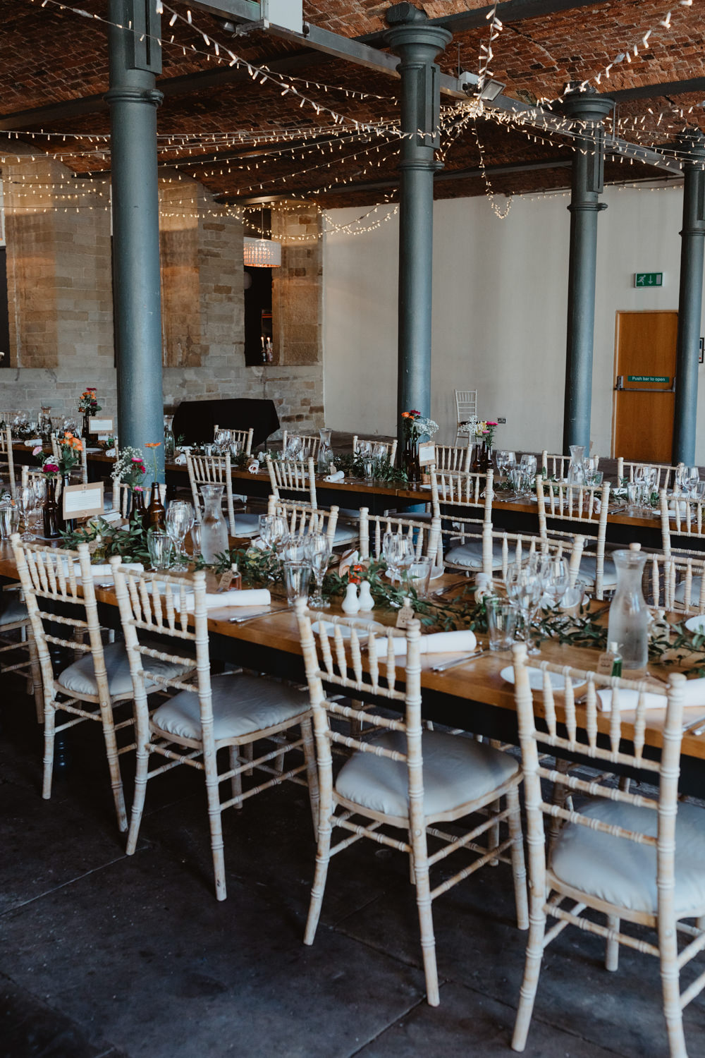 Warehouse Industrial Reception Long Tables Fairy Light Canopy Lighting Arches Dean Clough Wedding Stevie Jay Photography