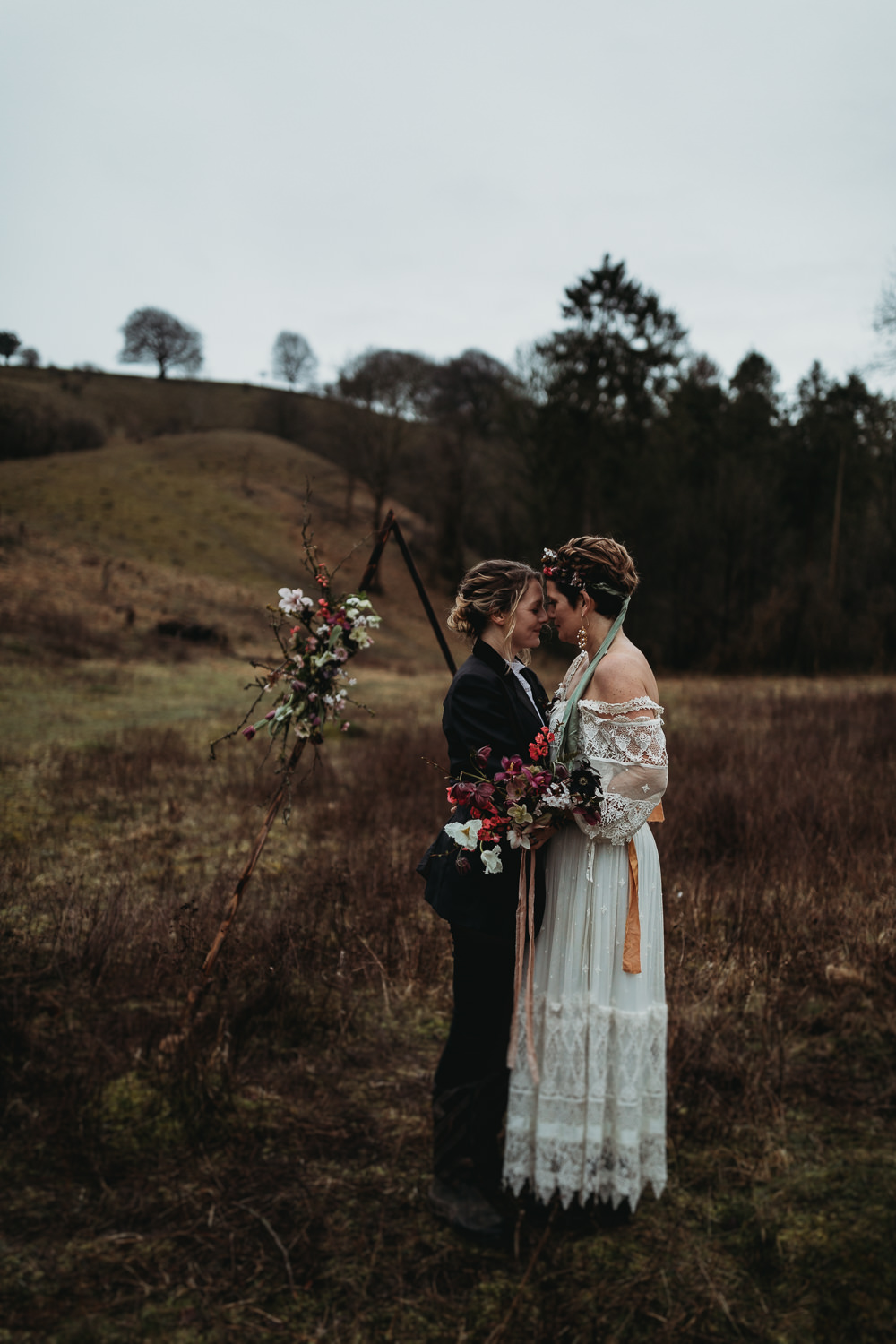 LGBTQ+ Elopement Thyme Lane Photography Triangle Flower Arch Backdrop Floral Wedding Ceremony Outdoors
