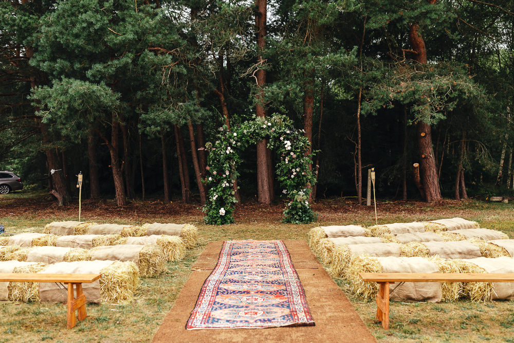 Woodland Outdoor Ceremony Flower Arch Persian Rug Aisle Greenery Foliage Festival Party Wedding Kirsty Mackenzie Photography