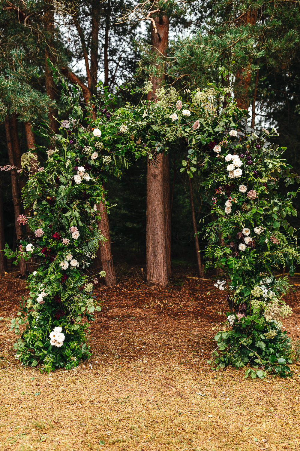 Woodland Outdoor Ceremony Flower Arch Persian Rug Aisle Greenery Foliage Festival Party Wedding Kirsty Mackenzie Photography