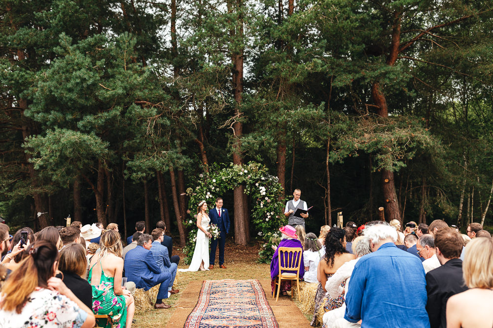 Woodland Outdoor Ceremony Flower Arch Persian Rug Aisle Greenery Foliage Festival Party Wedding Kirsty Mackenzie Photography