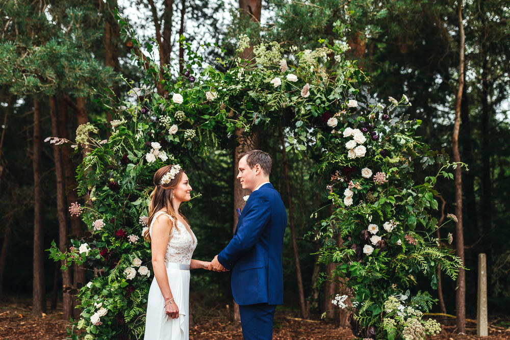 Woodland Outdoor Ceremony Flower Arch Persian Rug Aisle Greenery Foliage Festival Party Wedding Kirsty Mackenzie Photography