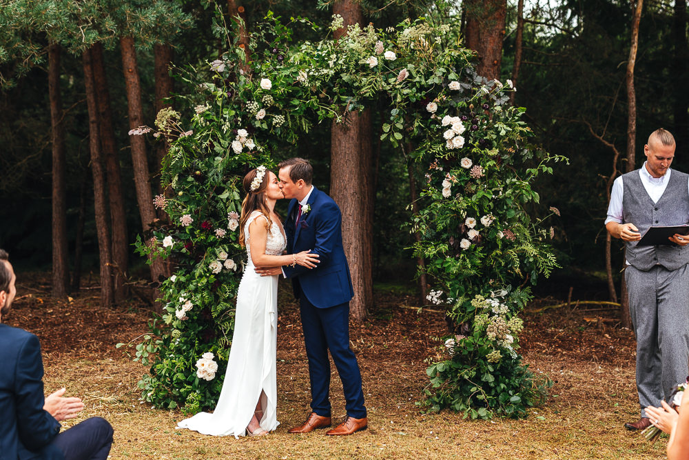 Woodland Outdoor Ceremony Flower Arch Persian Rug Aisle Greenery Foliage Festival Party Wedding Kirsty Mackenzie Photography
