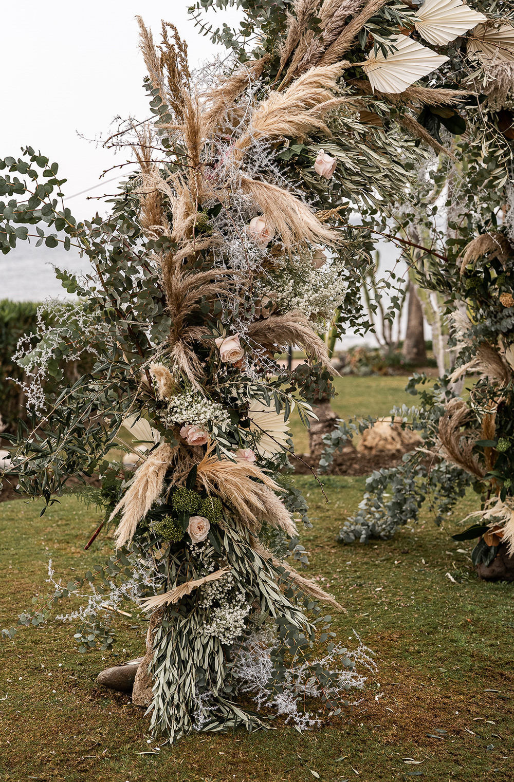 Flowers Dried Palm Leaves Greenery Foliage Orange Rose Pampas Grass Flower Arch Marbella Elopement Wedding Nora Photography
