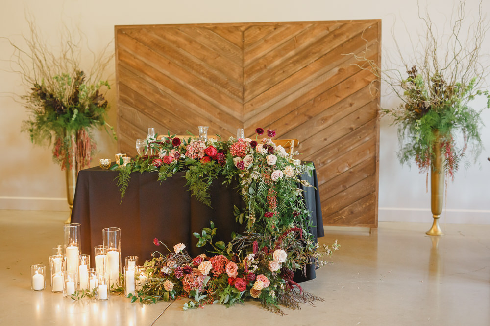 Table Decor Tablescape Flowers Black Plates Red Napkins Candles Top Table Sweetheart Enchanted Forest Wedding Kristen Booth Photography