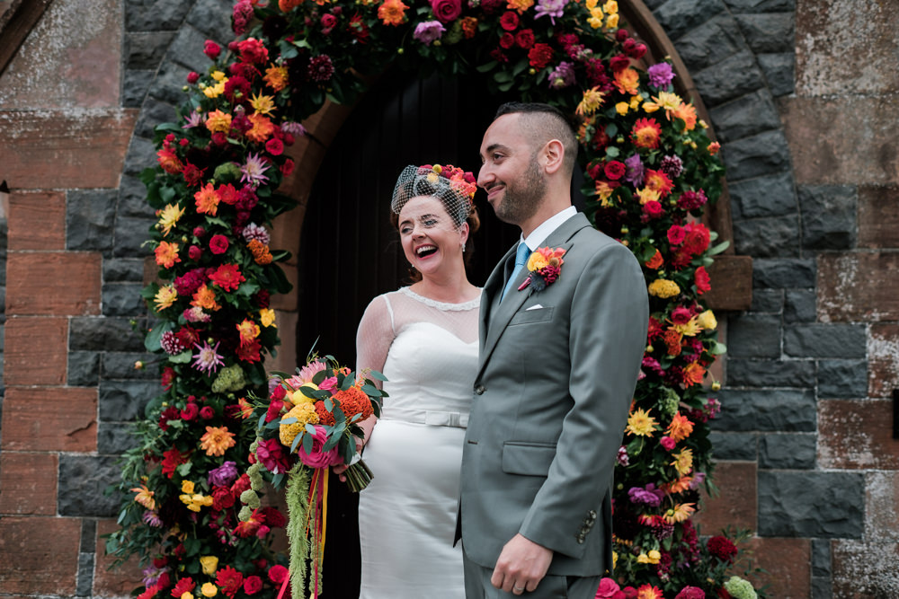 Glenarm Castle Wedding Jonathan Ryder Photography Flower Arch Church Ceremony Colourful