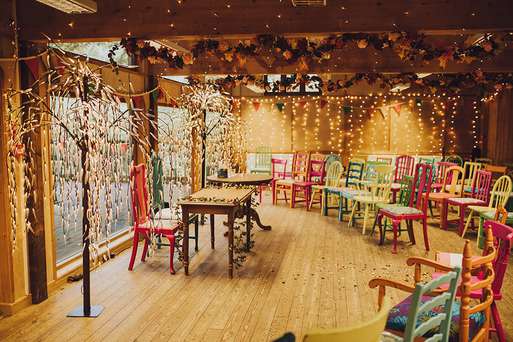Ceremony Room Fairy Lights Colourful Chairs Treehouse Wedding Honeydew Moments