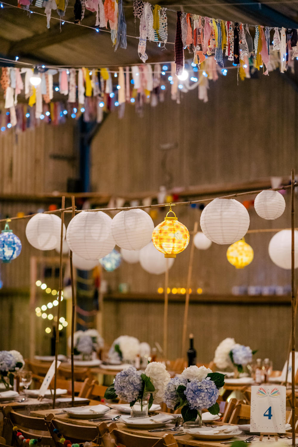 Rag Bunting Decor Barn Lanterns Fairy Lights Eclectic Wedding Paul and Tim Photographers