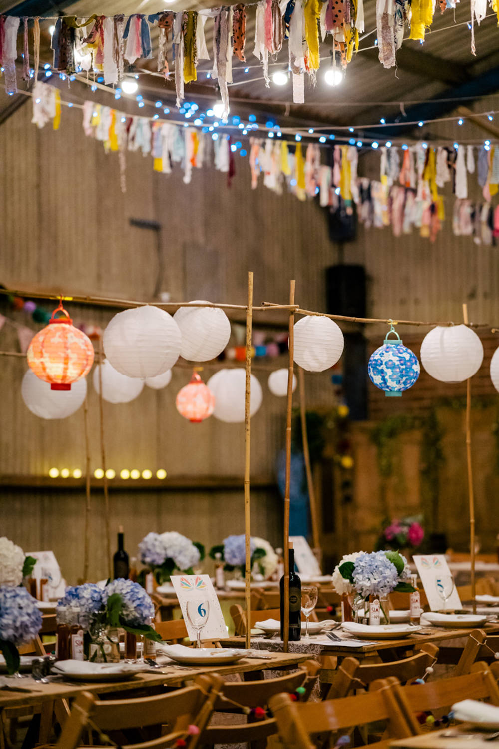 Rag Bunting Decor Barn Lanterns Fairy Lights Eclectic Wedding Paul and Tim Photographers