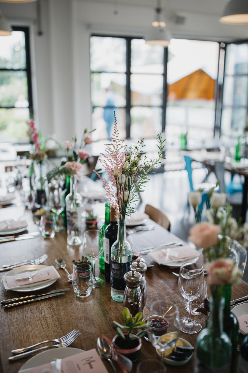 Wooden Table Bottle Flowers Pastel Decor Field Kitchen Wedding Siobhan Amy Photography