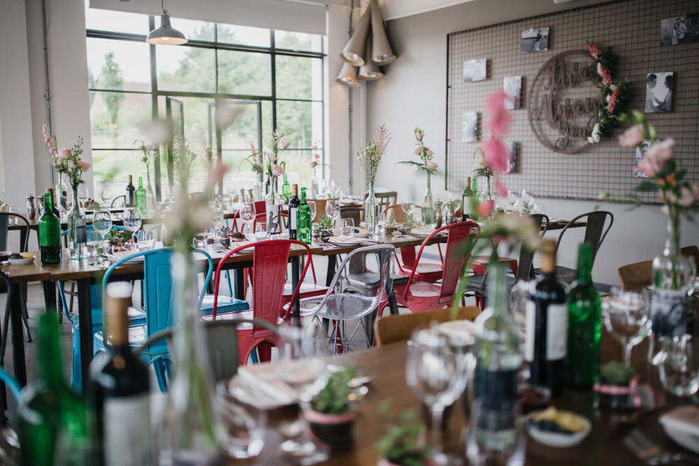 Wooden Table Bottle Flowers Pastel Decor Mismatched Industrial Chairs Field Kitchen Wedding Siobhan Amy Photography